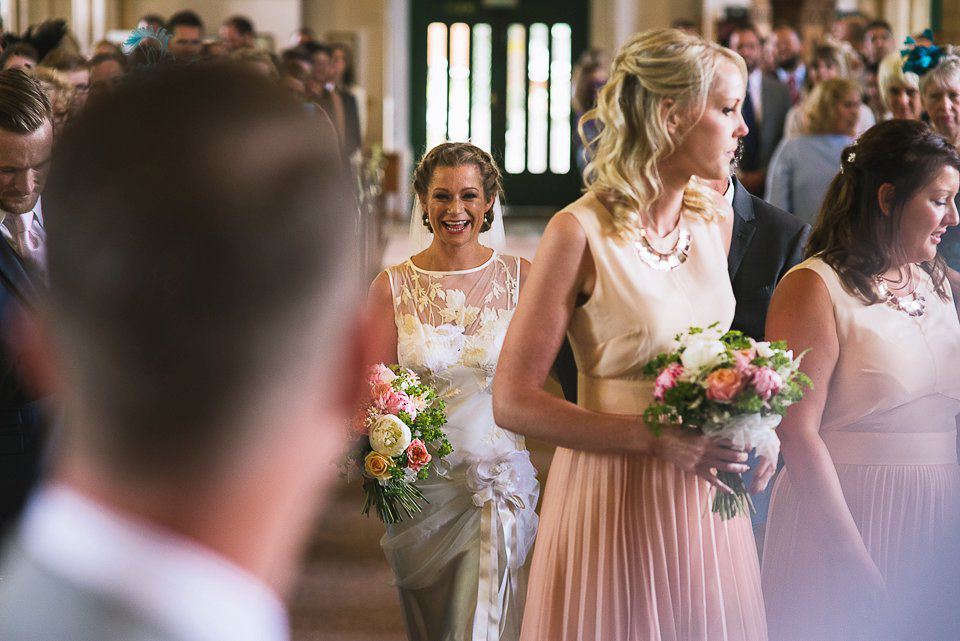 Bryony wore a gown with a floral back by Claire Pettibone from Blackburn Bridal for her Summer wedding held at her husband's family home. Photography by Kristian Leven.