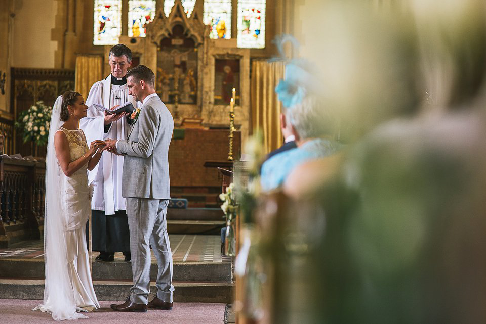 Bryony wore a gown with a floral back by Claire Pettibone from Blackburn Bridal for her Summer wedding held at her husband's family home. Photography by Kristian Leven.