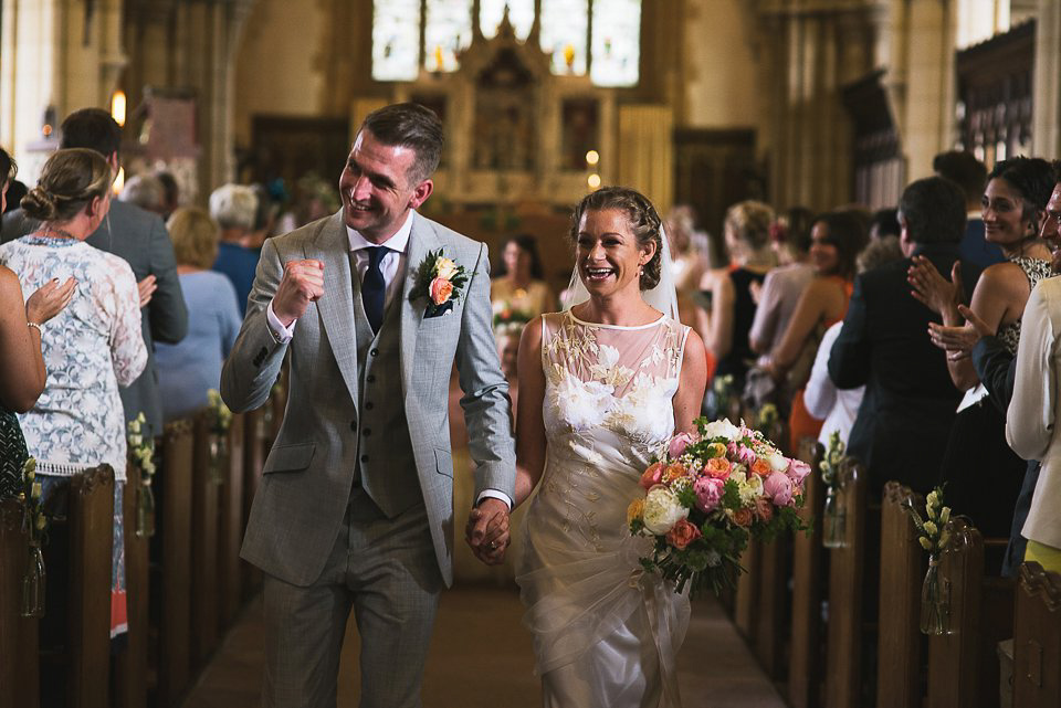 Bryony wore a gown with a floral back by Claire Pettibone from Blackburn Bridal for her Summer wedding held at her husband's family home. Photography by Kristian Leven.