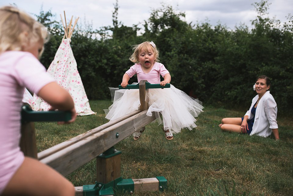 Bryony wore a gown with a floral back by Claire Pettibone from Blackburn Bridal for her Summer wedding held at her husband's family home. Photography by Kristian Leven.