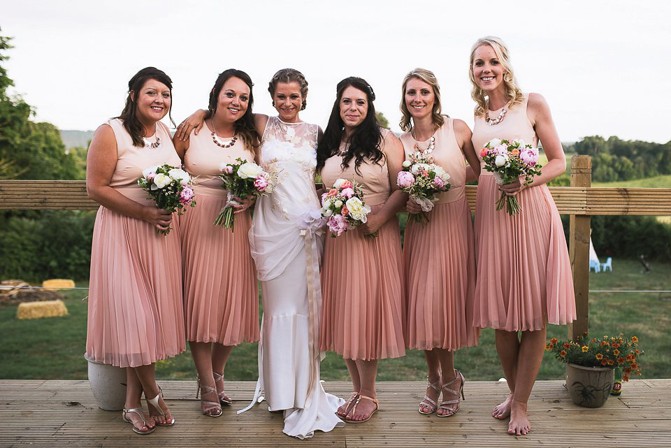 Bryony wore a gown with a floral back by Claire Pettibone from Blackburn Bridal for her Summer wedding held at her husband's family home. Photography by Kristian Leven.