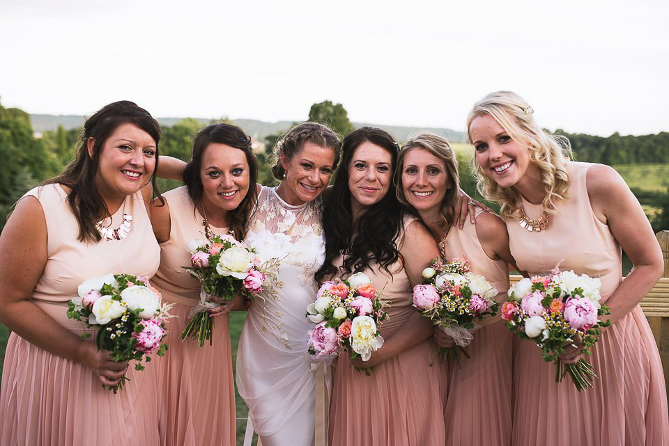 Bryony wore a gown with a floral back by Claire Pettibone from Blackburn Bridal for her Summer wedding held at her husband's family home. Photography by Kristian Leven.