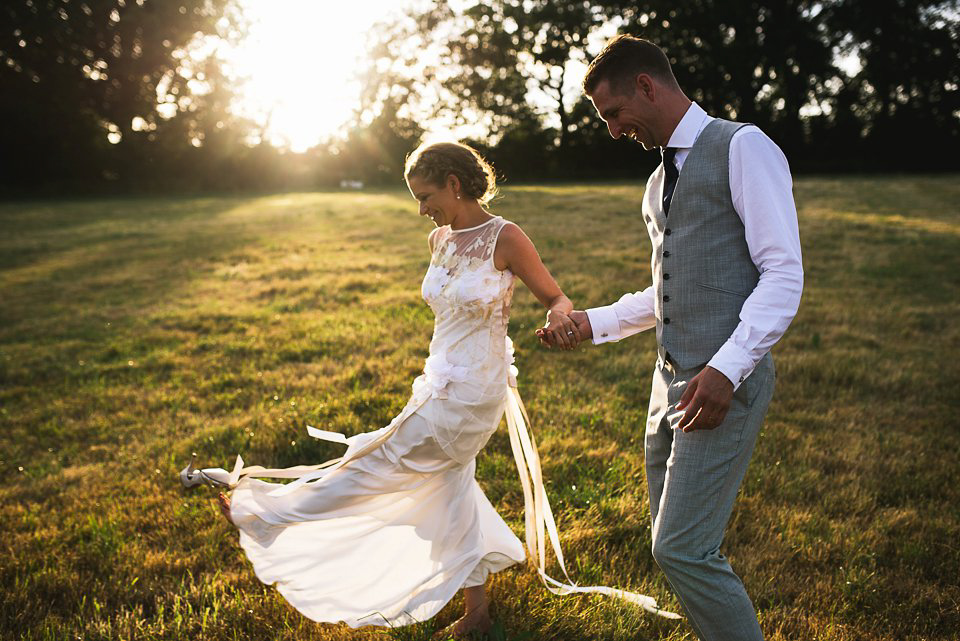 Bryony wore a gown with a floral back by Claire Pettibone from Blackburn Bridal for her Summer wedding held at her husband's family home. Photography by Kristian Leven.