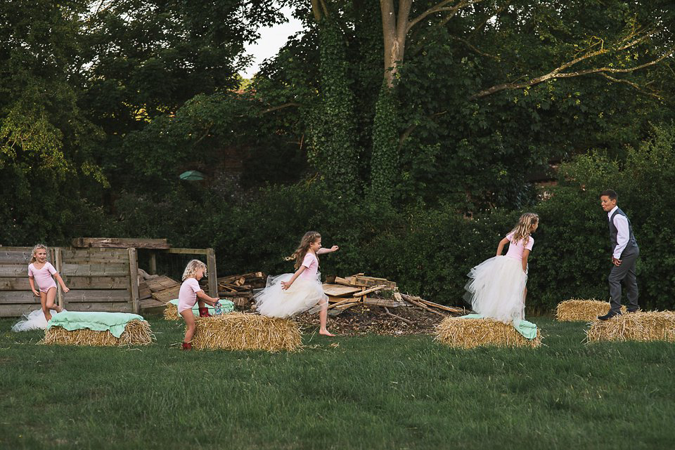 Bryony wore a gown with a floral back by Claire Pettibone from Blackburn Bridal for her Summer wedding held at her husband's family home. Photography by Kristian Leven.