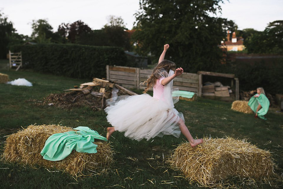 Bryony wore a gown with a floral back by Claire Pettibone from Blackburn Bridal for her Summer wedding held at her husband's family home. Photography by Kristian Leven.