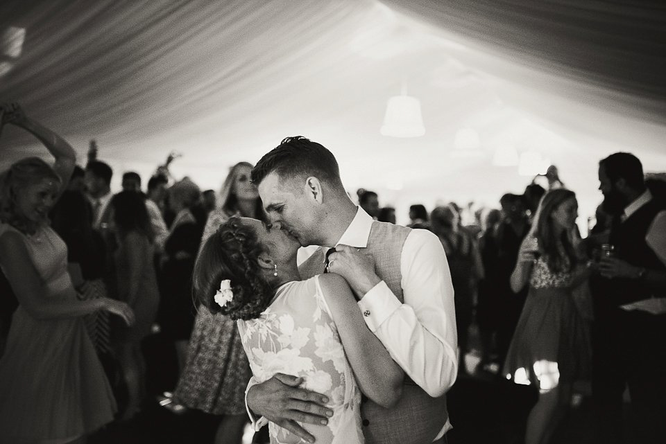 Bryony wore a gown with a floral back by Claire Pettibone from Blackburn Bridal for her Summer wedding held at her husband's family home. Photography by Kristian Leven.