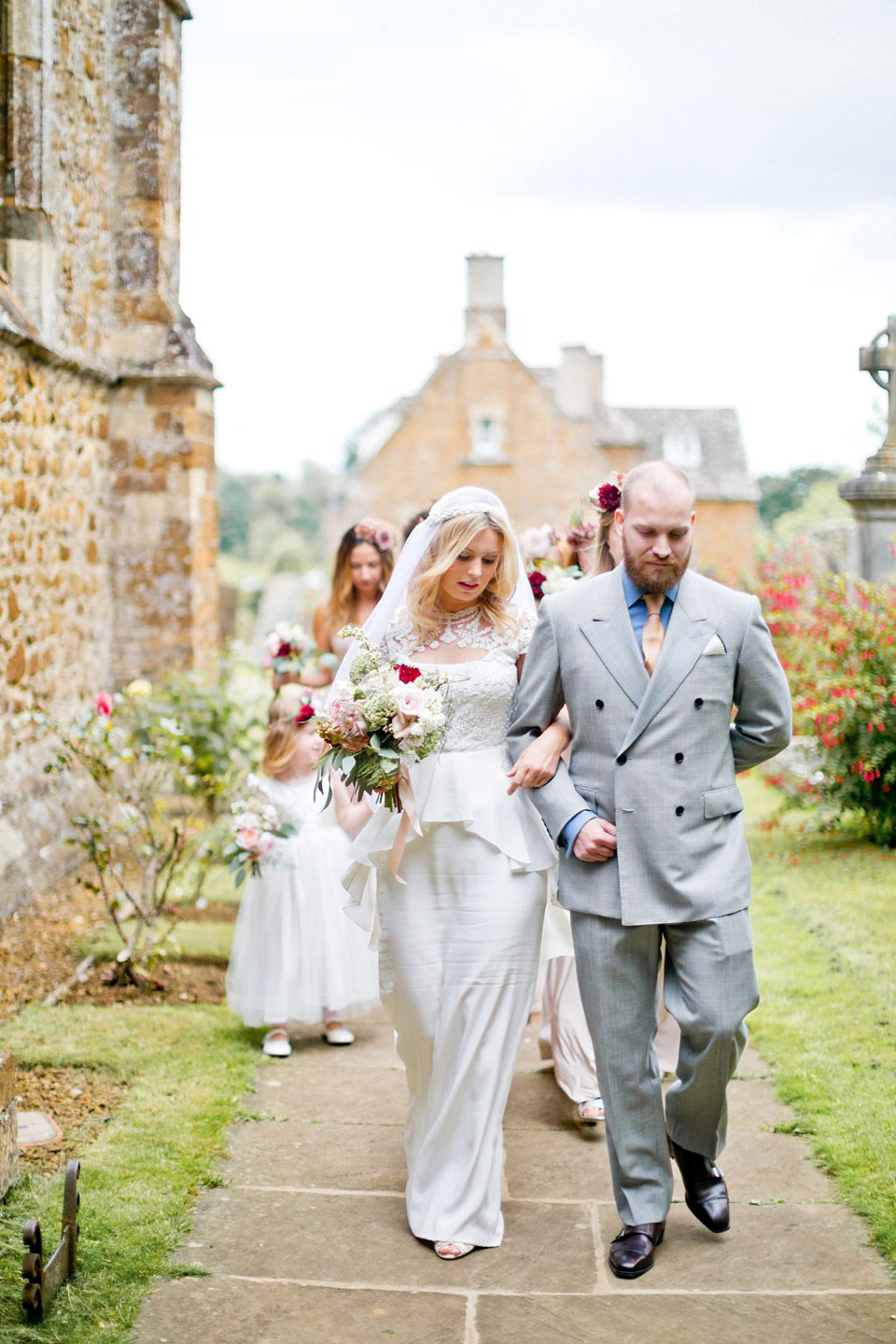 George wears a Temperley London gown with beautiful peplum detail for her eccentric, quirky and elegant Aynhoe Park wedding. Photography by Caught The Light.