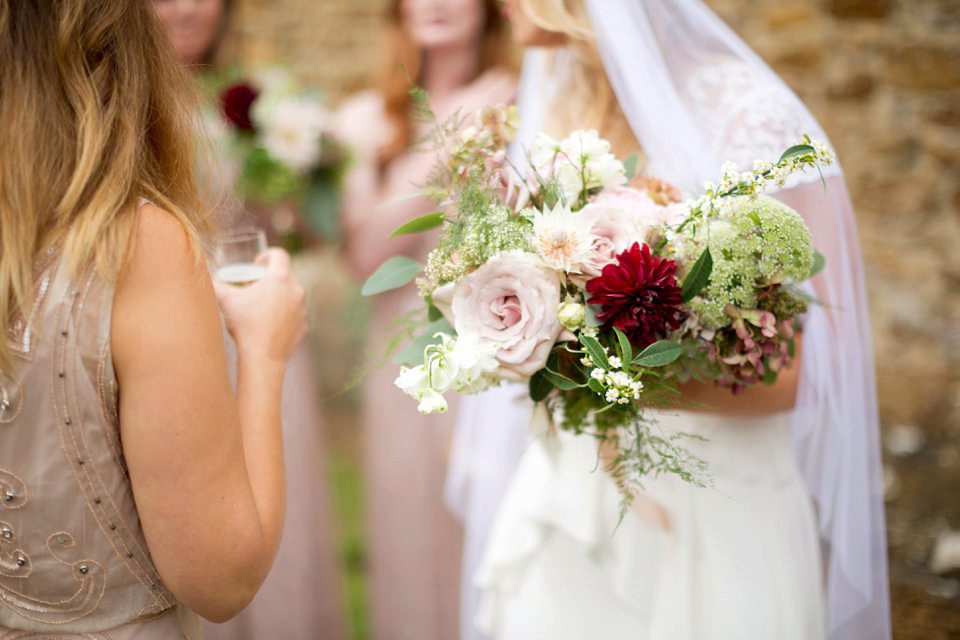 George wears a Temperley London gown with beautiful peplum detail for her eccentric, quirky and elegant Aynhoe Park wedding. Photography by Caught The Light.