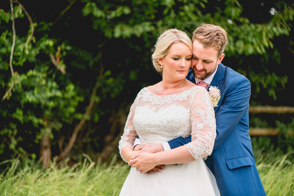 Rebecca wore a gown by Charlotte Balbier for her romantic and quintessentially English country wedding. Photography by Lisa Carpenter.