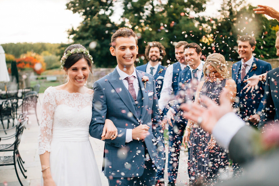 Katie wore a bespoke gown by London based designer Shanna Melville for her romantic Autumn wedding in the Cotswolds. Photography by Joseph Hall.