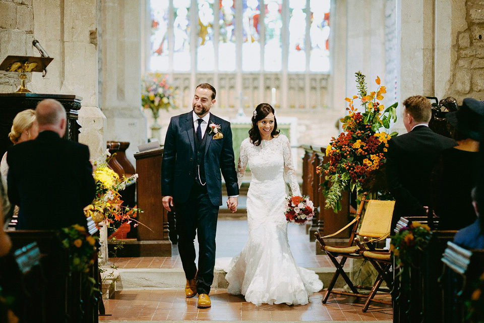 An elegant and quintessentially English village hall wedding in the Cotswolds. Bride Claire wore Ellis Bridals. Photography by David Jenkins.