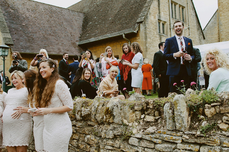 An elegant and quintessentially English village hall wedding in the Cotswolds. Bride Claire wore Ellis Bridals. Photography by David Jenkins.