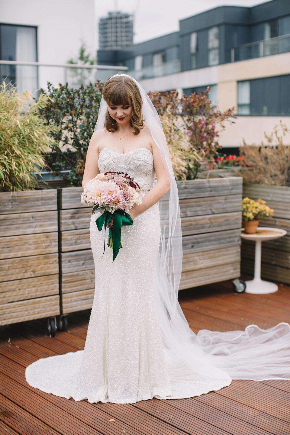 The bride wore a Karen Willis Holmes gown for her London wedding in shades of green. Photography by Alex Wysocki.