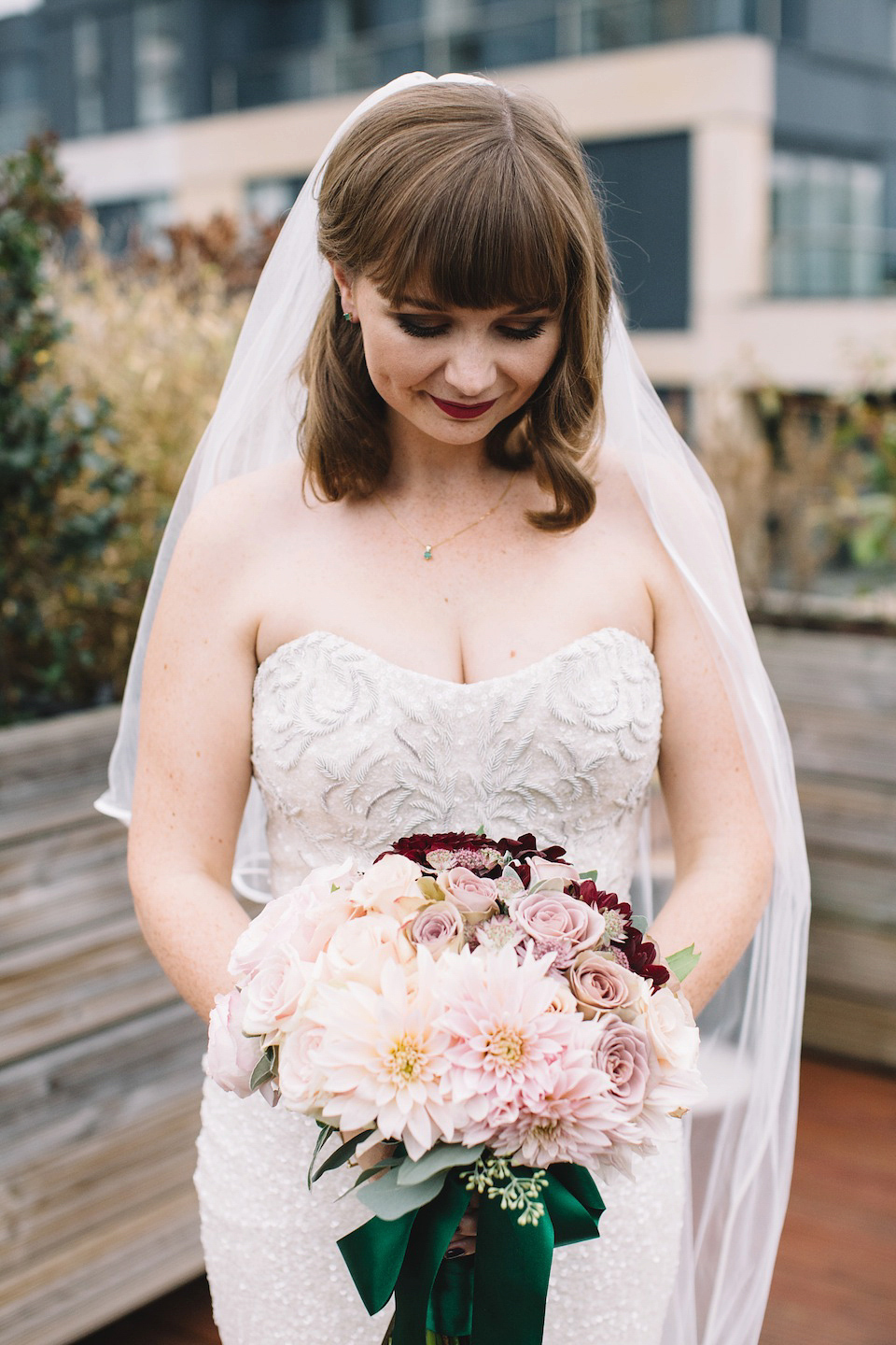 The bride wore a Karen Willis Holmes gown for her London wedding in shades of green. Photography by Alex Wysocki.