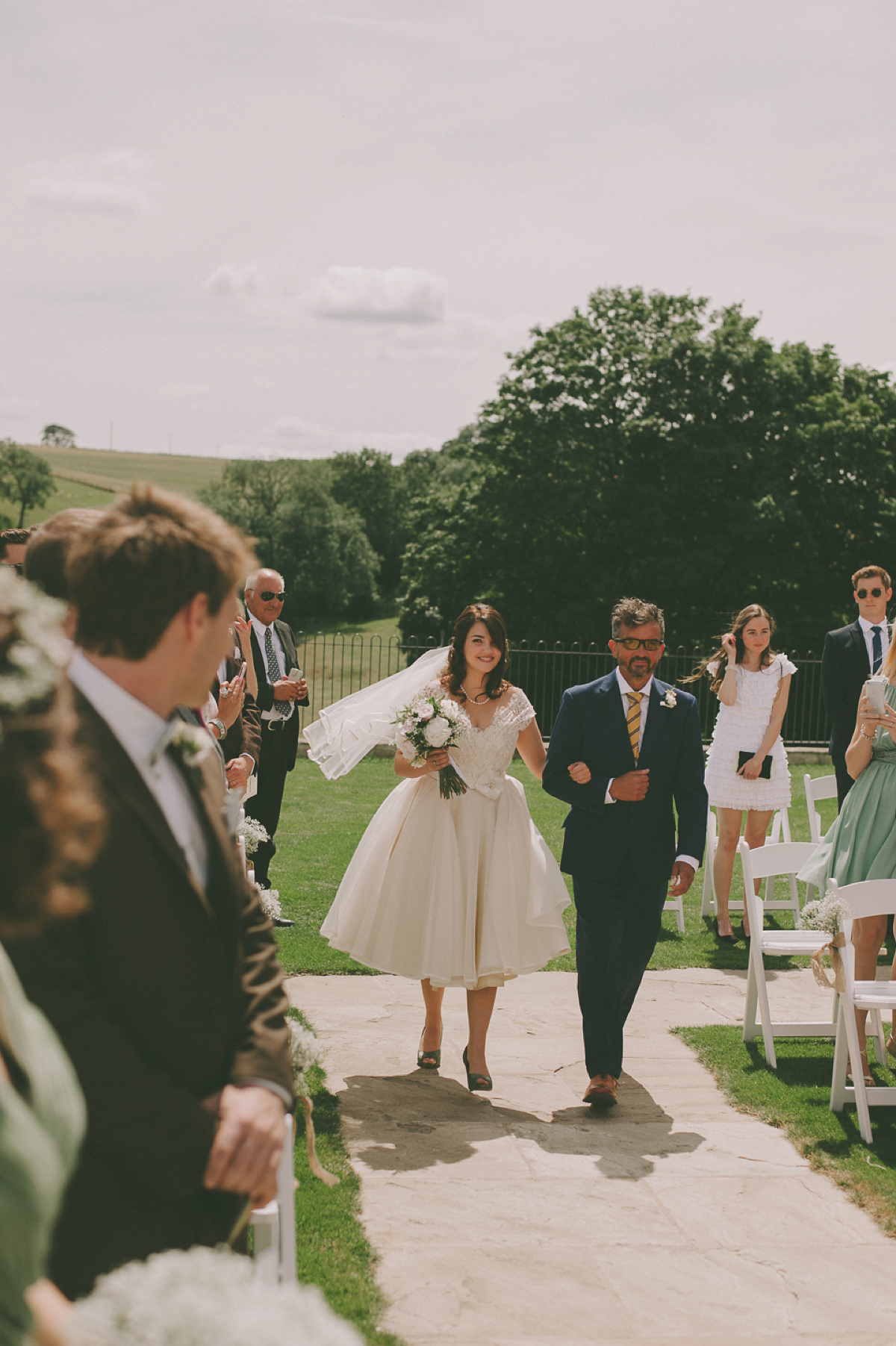 Green shoes ane a 50's inspired dress for a vintage barn wedding in the Cotswolds. Dress by Joanne Fleming, photography by Nabeel's Camera.