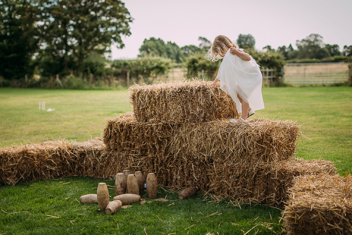 A beaded and tassled Eliza Jane Howell gown and maids in coral pink. Miki Photography.