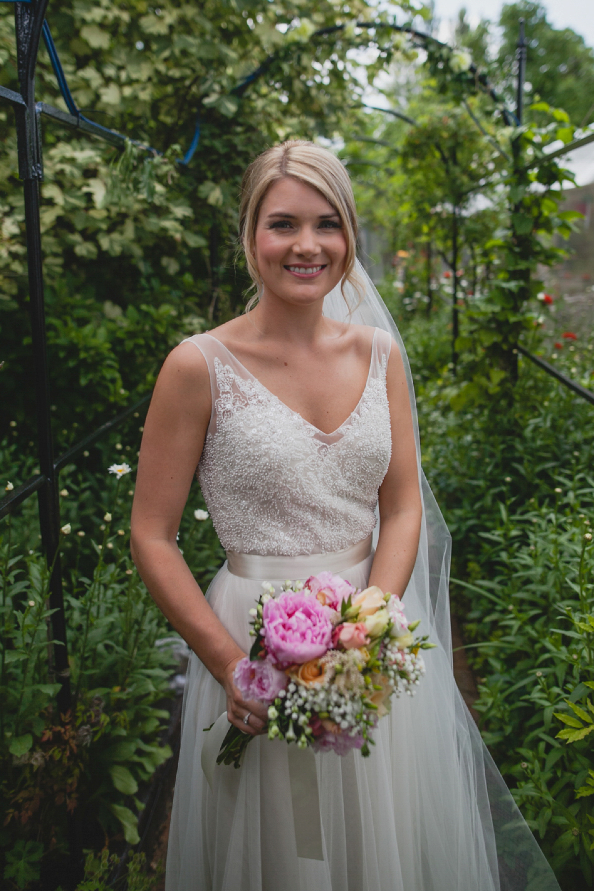 Bride Leah wears a Watters gown for her romantic and pretty English country garden wedding. Photography by Sally T.