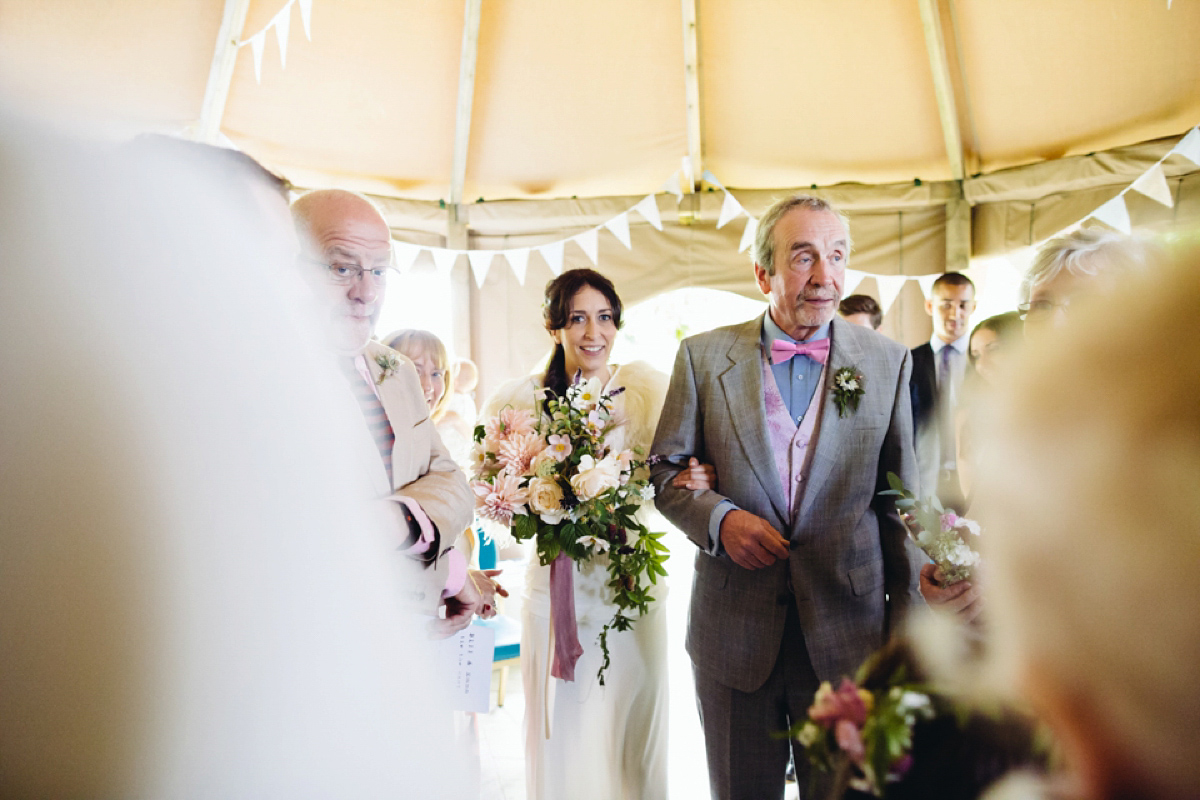 A backless Charlie Brear gown for a festival style tipi wedding in Cornwall. Photography by Lucy Little.