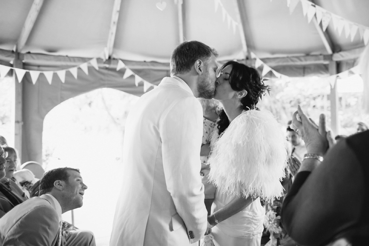 A backless Charlie Brear gown for a festival style tipi wedding in Cornwall. Photography by Lucy Little.