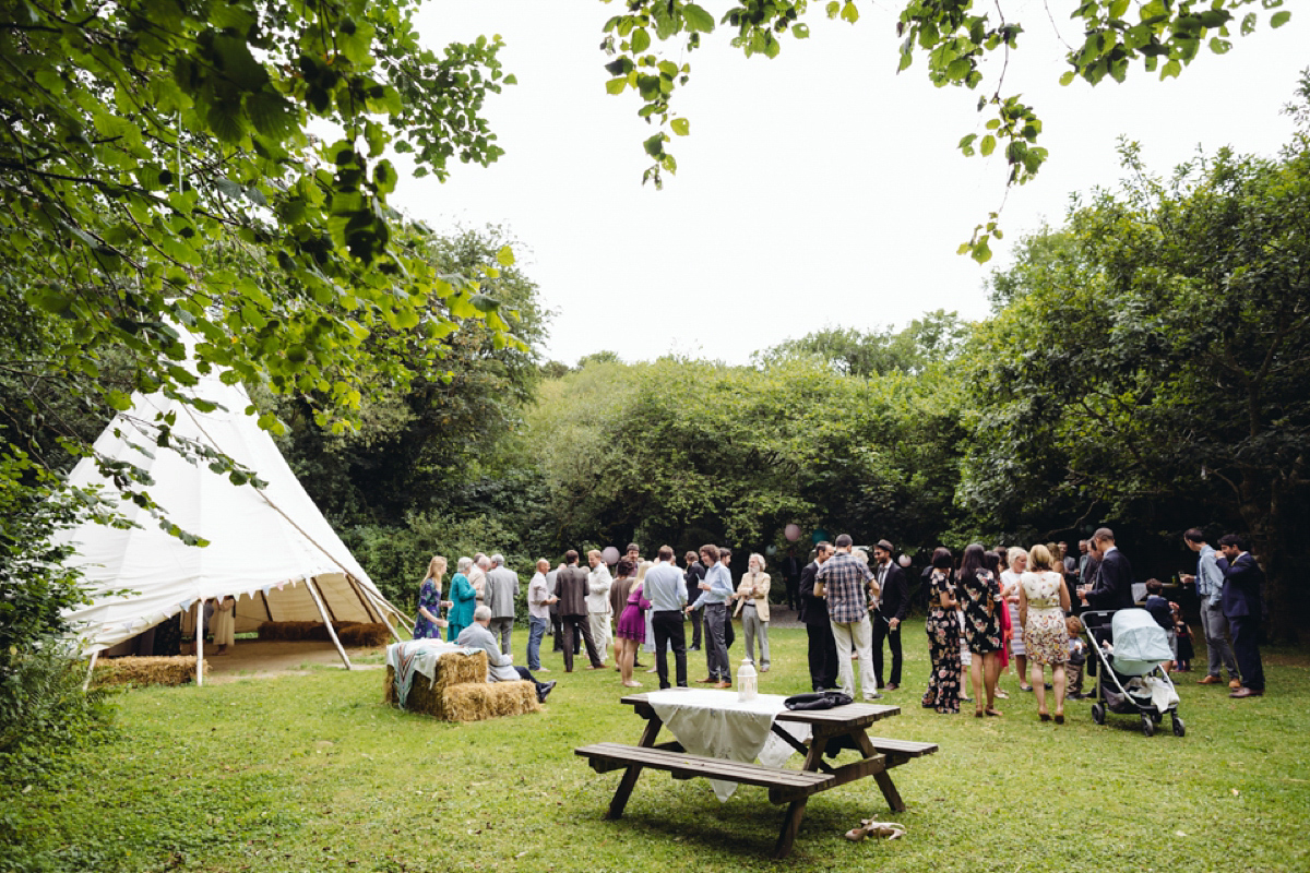 A backless Charlie Brear gown for a festival style tipi wedding in Cornwall. Photography by Lucy Little.