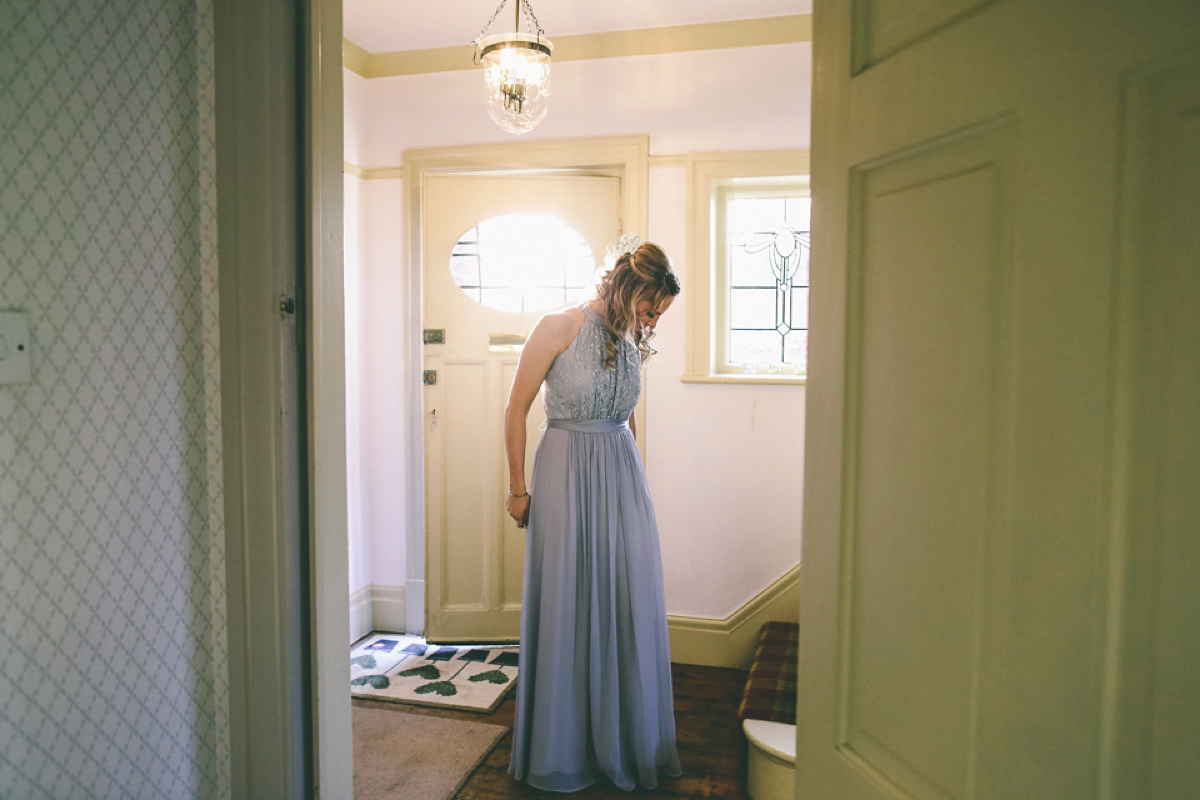 Jess wears an Eliza Jane Howell dress for her winter village hall wedding. Photography by Emma Boileau.