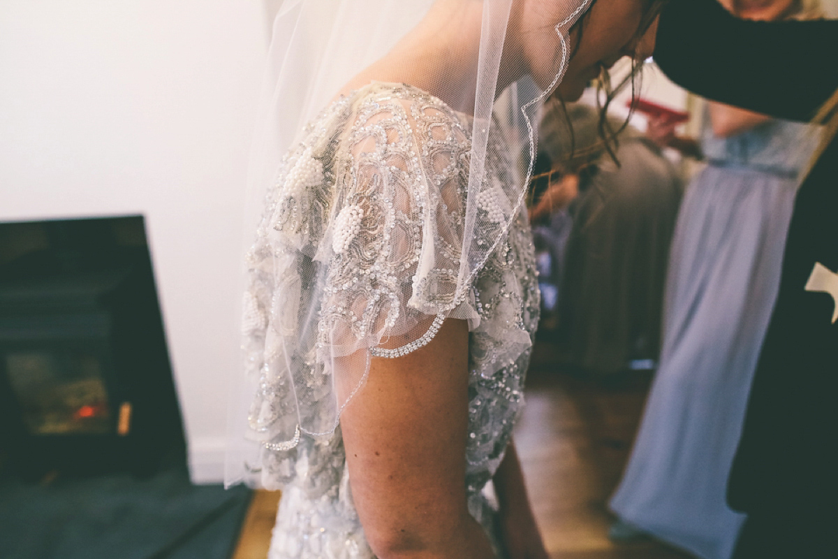 Jess wears an Eliza Jane Howell dress for her winter village hall wedding. Photography by Emma Boileau.