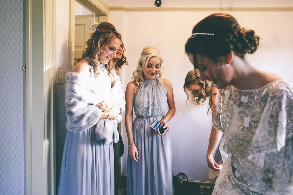 Jess wears an Eliza Jane Howell dress for her winter village hall wedding. Photography by Emma Boileau.