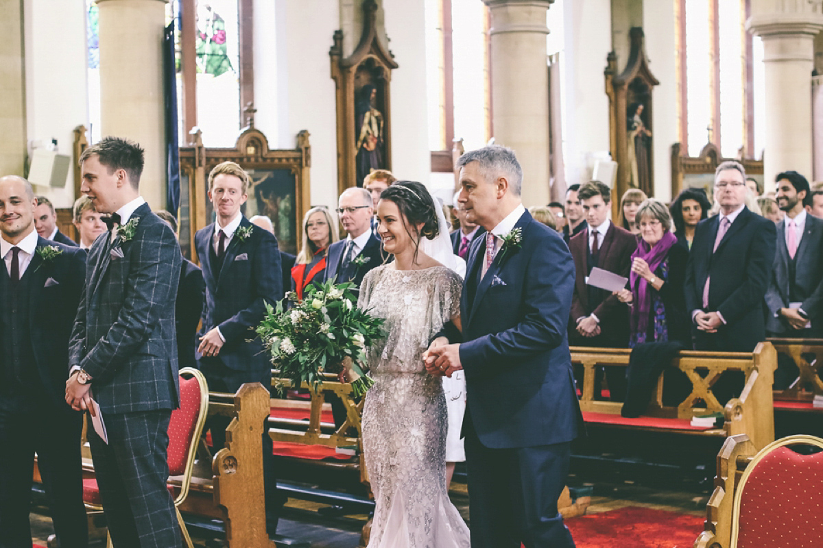 Jess wears an Eliza Jane Howell dress for her winter village hall wedding. Photography by Emma Boileau.