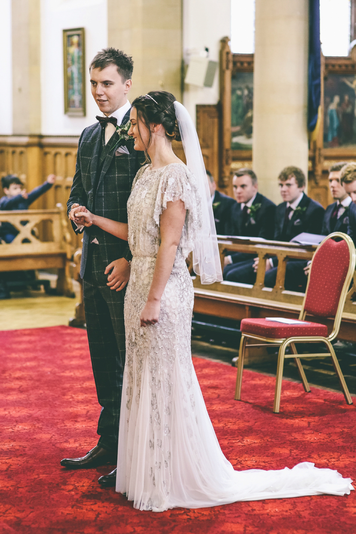 Jess wears an Eliza Jane Howell dress for her winter village hall wedding. Photography by Emma Boileau.