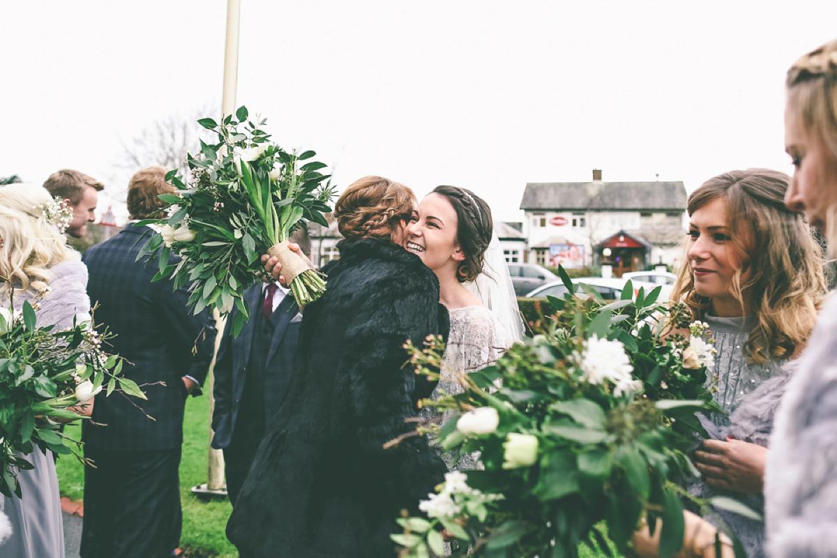 Jess wears an Eliza Jane Howell dress for her winter village hall wedding. Photography by Emma Boileau.