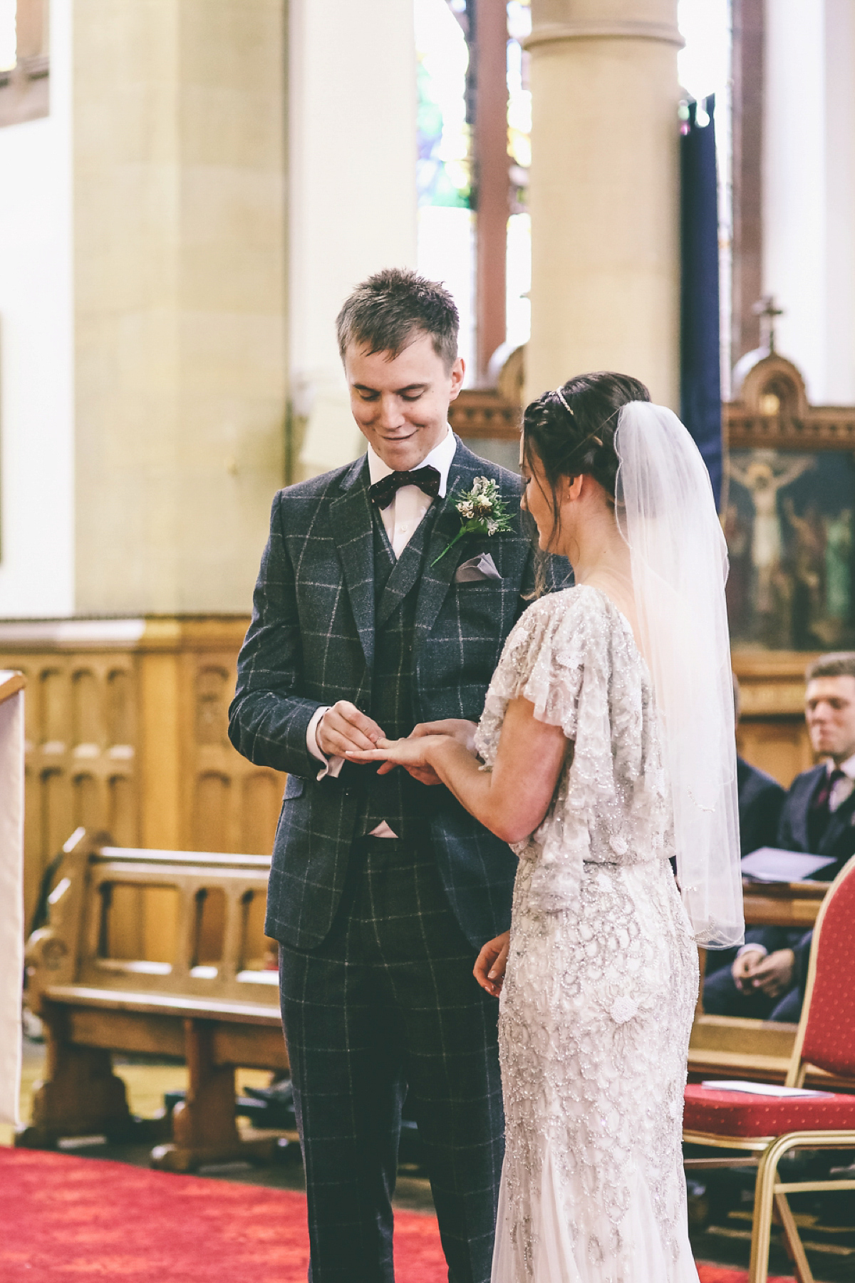 Jess wears an Eliza Jane Howell dress for her winter village hall wedding. Photography by Emma Boileau.