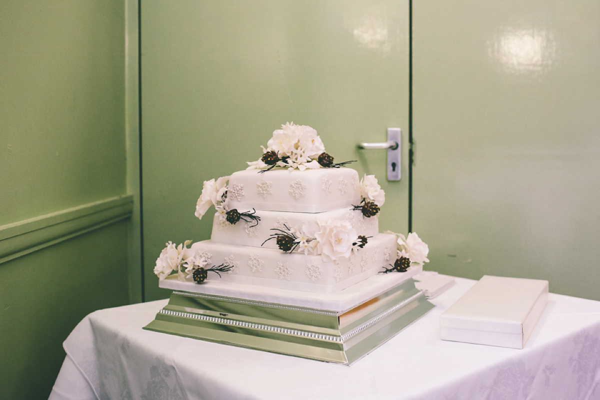 Jess wears an Eliza Jane Howell dress for her winter village hall wedding. Photography by Emma Boileau.