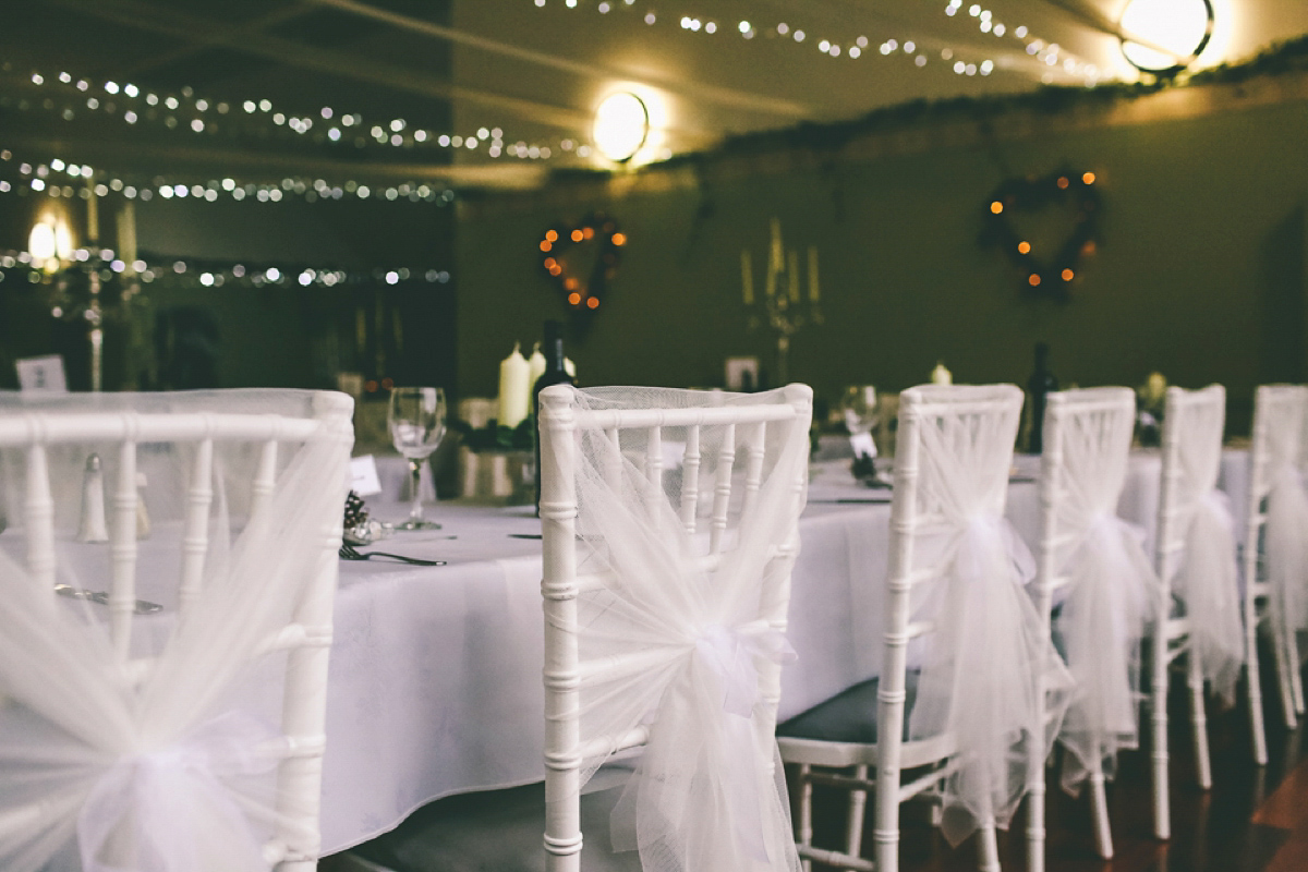 Jess wears an Eliza Jane Howell dress for her winter village hall wedding. Photography by Emma Boileau.