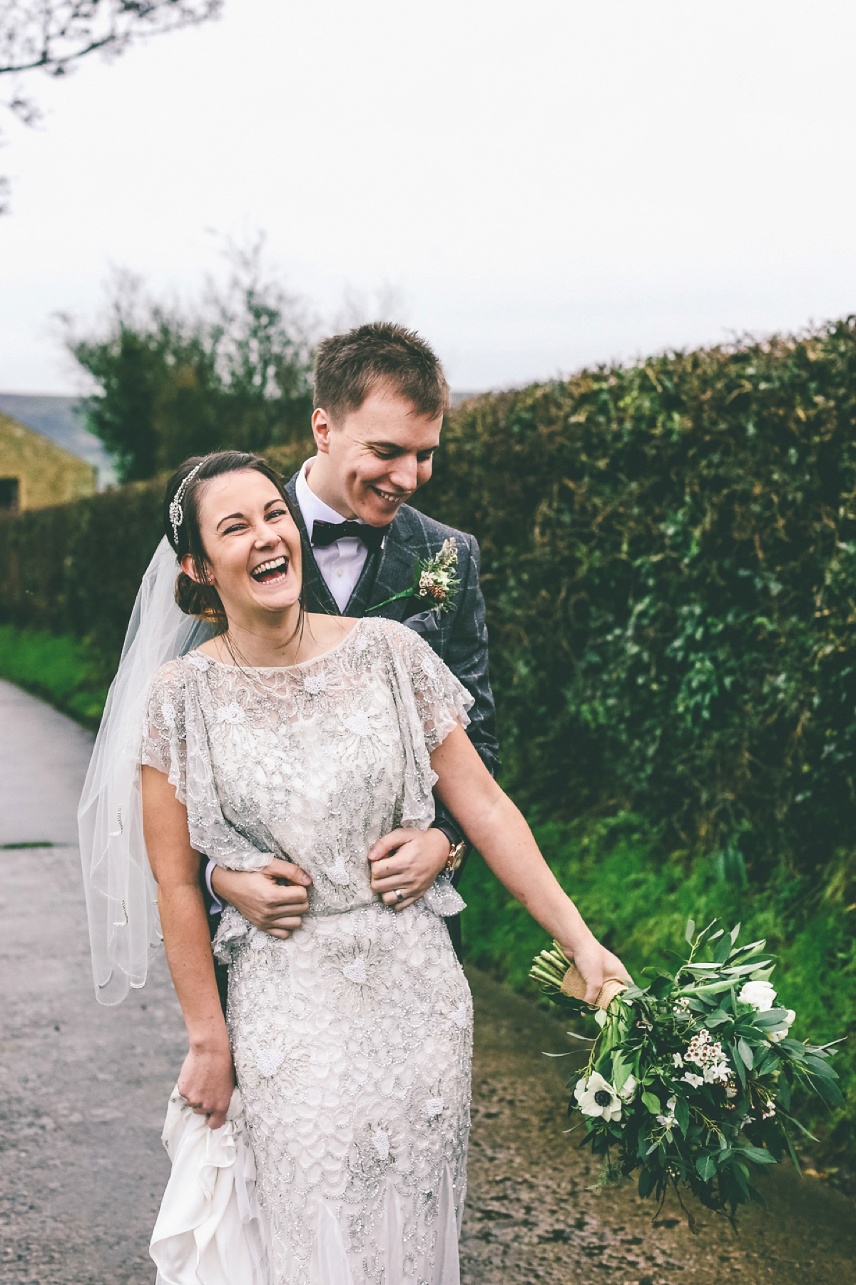 Jess wears an Eliza Jane Howell dress for her winter village hall wedding. Photography by Emma Boileau.