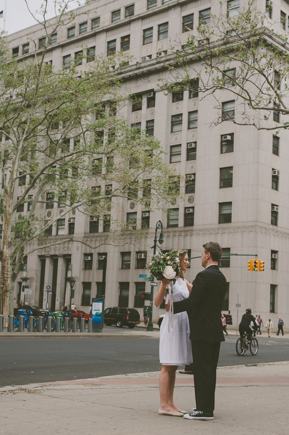 The bride wears a short dress she made herself for her intimate New York city wedding. Photography by Nabeel Khan.