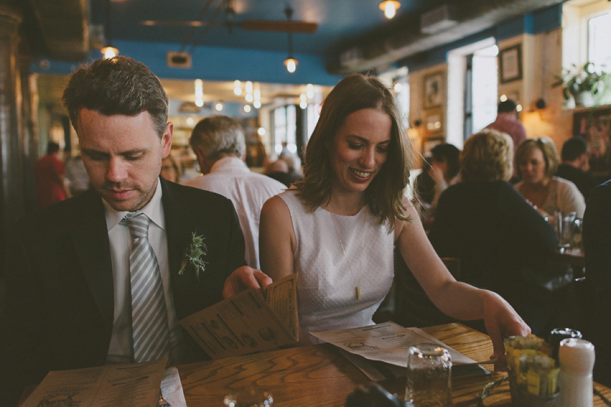 The bride wears a short dress she made herself for her intimate New York city wedding. Photography by Nabeel Khan.