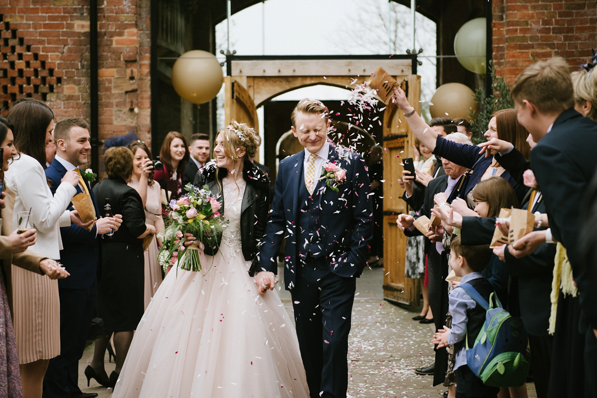 Jade wore a leather jacket with her Allure Bridals gown. Photography by Ed Godden.