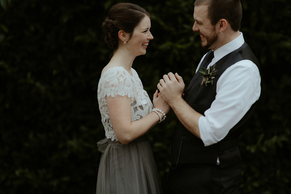 The bride wears a Jenny Yoo gown in soft grey tulle for her rustic Italian villa wedding. Photography by Cinzia Bruschini.