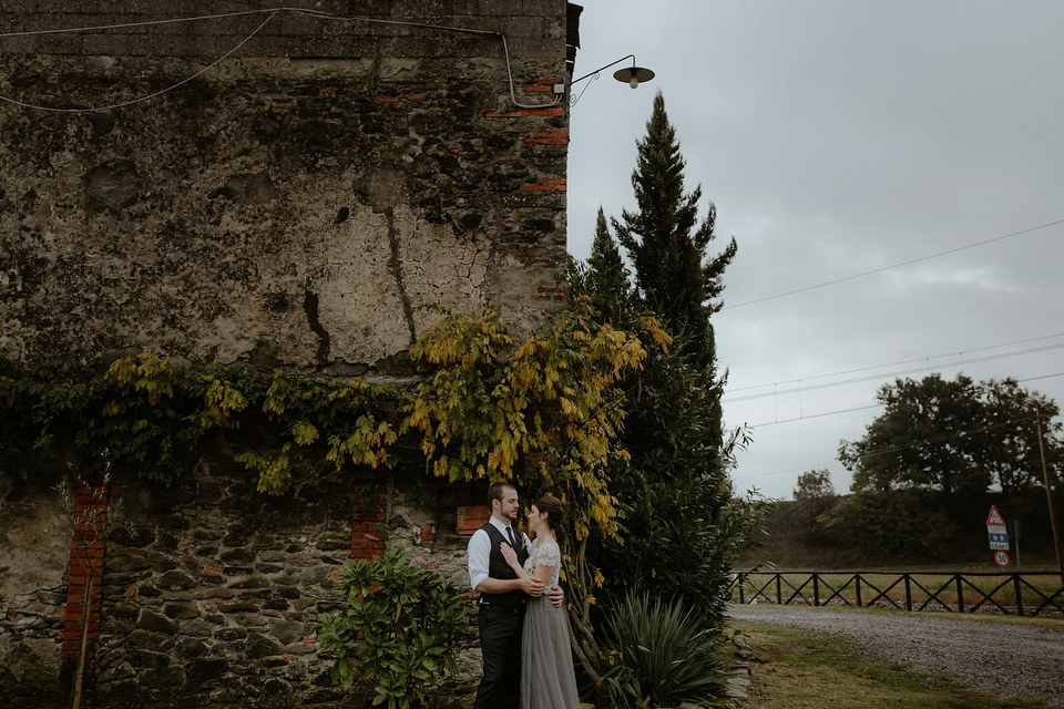 The bride wears a Jenny Yoo gown in soft grey tulle for her rustic Italian villa wedding. Photography by Cinzia Bruschini.