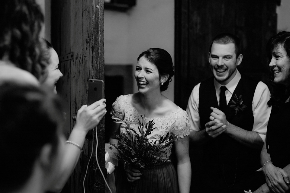 The bride wears a Jenny Yoo gown in soft grey tulle for her rustic Italian villa wedding. Photography by Cinzia Bruschini.