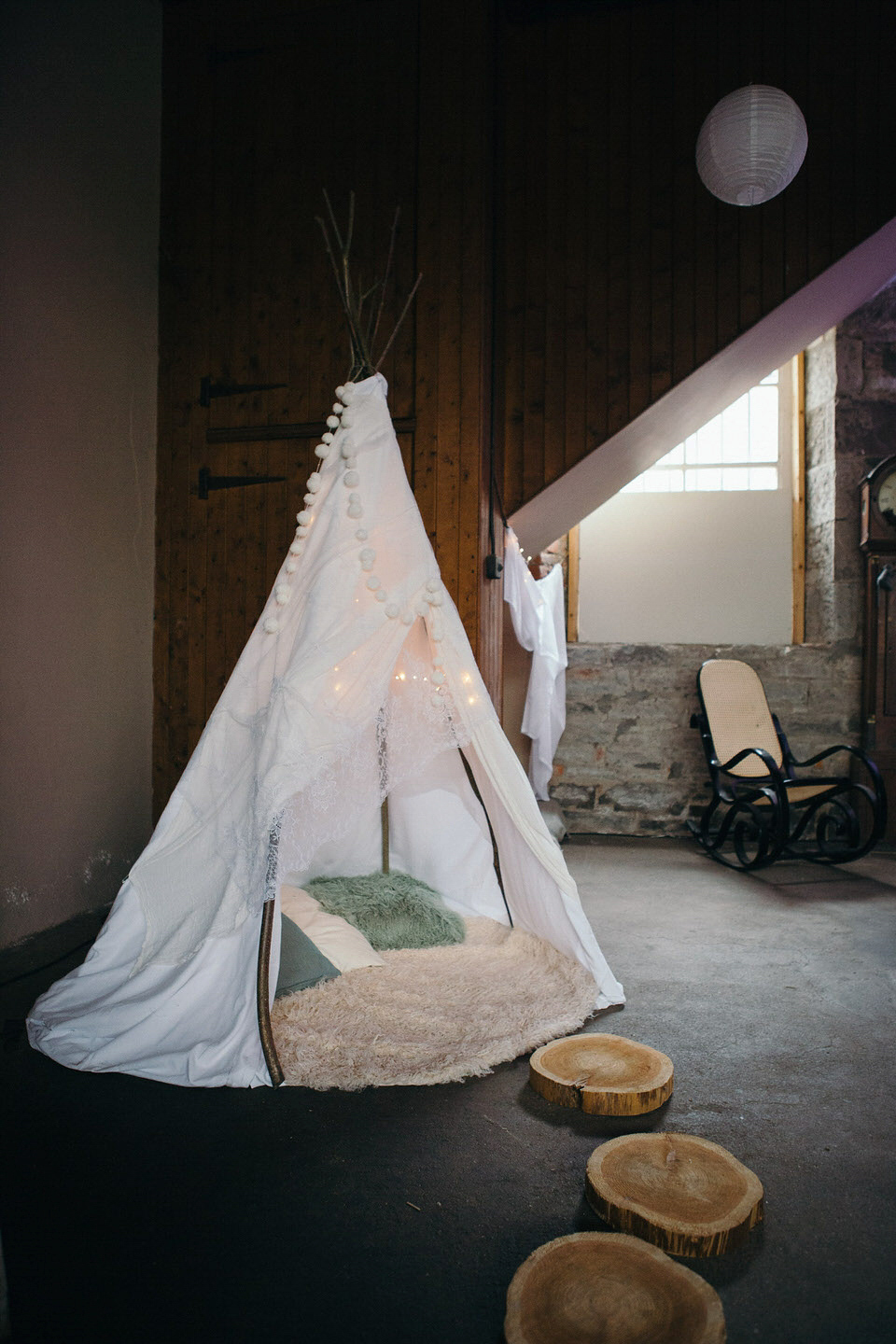 A tweed jacket and feathers in her hair for a boho bride and her eclectic woodland wedding. Images by Mirrorbox Photography.