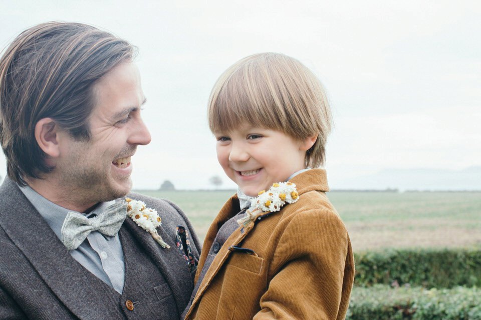 A tweed jacket and feathers in her hair for a boho bride and her eclectic woodland wedding. Images by Mirrorbox Photography.