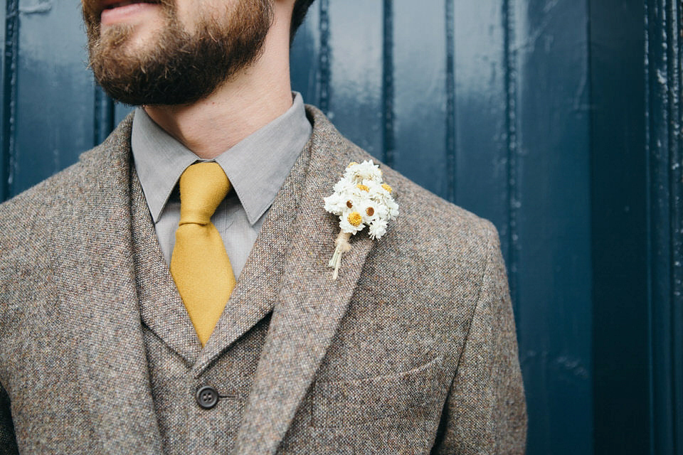 A tweed jacket and feathers in her hair for a boho bride and her eclectic woodland wedding. Images by Mirrorbox Photography.