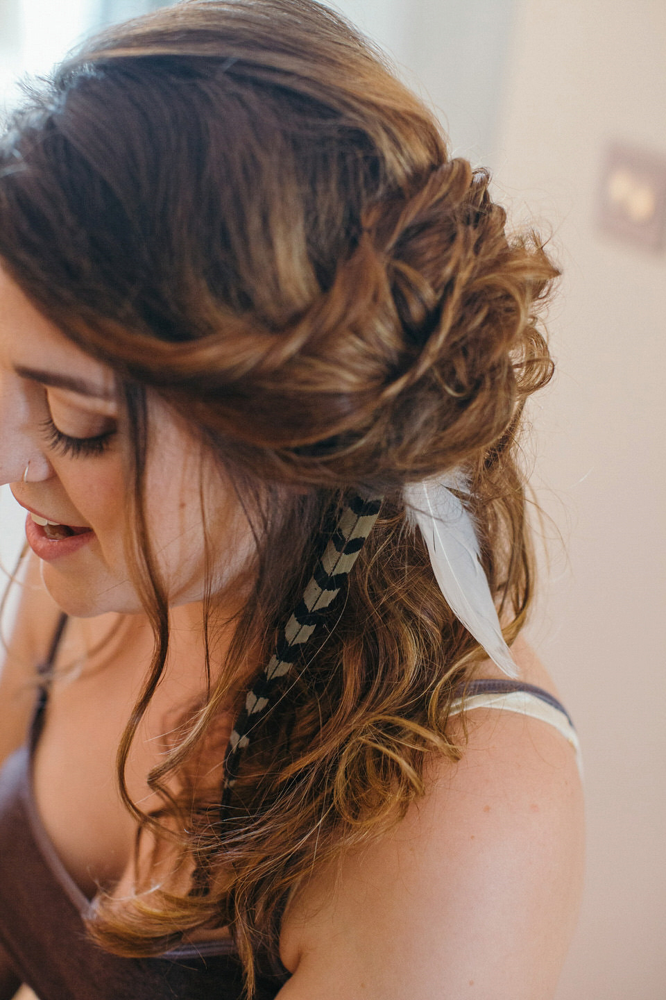 A tweed jacket and feathers in her hair for a boho bride and her eclectic woodland wedding. Images by Mirrorbox Photography.