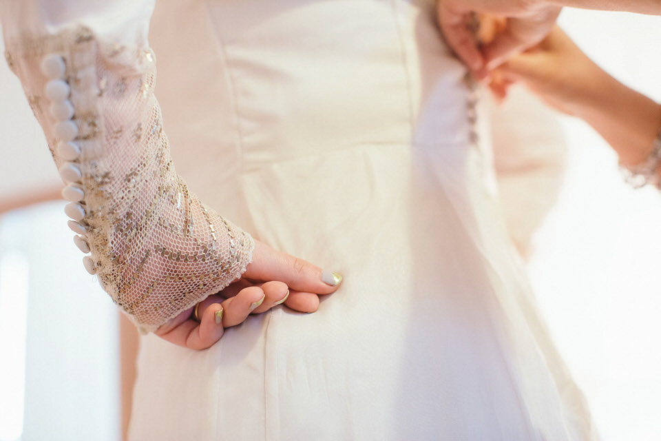 A tweed jacket and feathers in her hair for a boho bride and her eclectic woodland wedding. Images by Mirrorbox Photography.