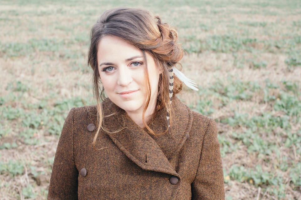 A tweed jacket and feathers in her hair for a boho bride and her eclectic woodland wedding. Images by Mirrorbox Photography.