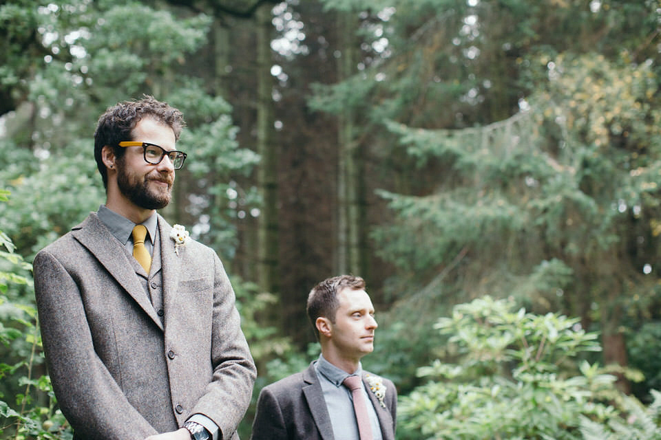 A tweed jacket and feathers in her hair for a boho bride and her eclectic woodland wedding. Images by Mirrorbox Photography.