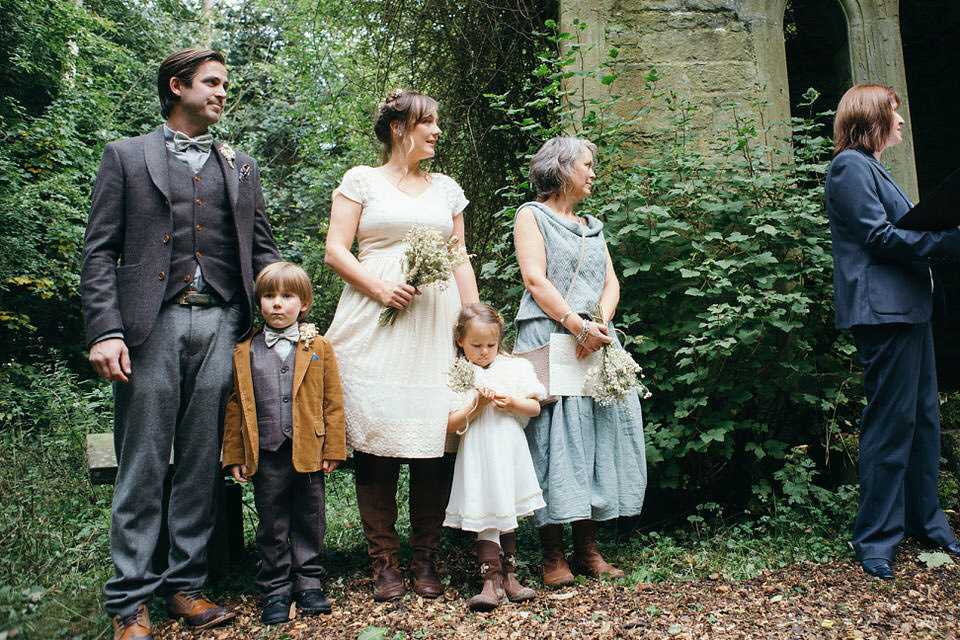 A tweed jacket and feathers in her hair for a boho bride and her eclectic woodland wedding. Images by Mirrorbox Photography.