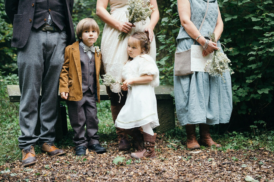 A tweed jacket and feathers in her hair for a boho bride and her eclectic woodland wedding. Images by Mirrorbox Photography.