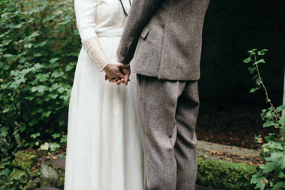 A tweed jacket and feathers in her hair for a boho bride and her eclectic woodland wedding. Images by Mirrorbox Photography.